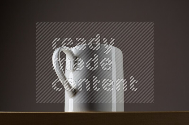 Low angle shot of a white cup on grey background
