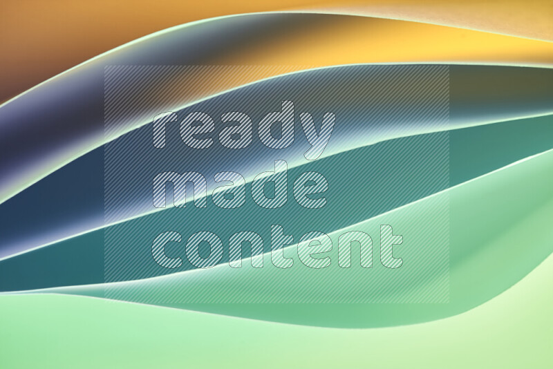 This image showcases an abstract paper art composition with paper curves in green and orange gradients created by colored light