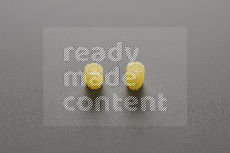 Small rings pasta on grey background