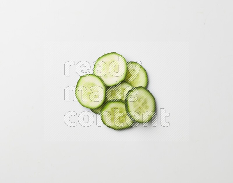 Multiple cucumber slices on white background