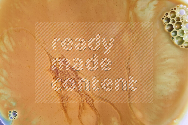 A close-up of abstract different swirling patterns in orange