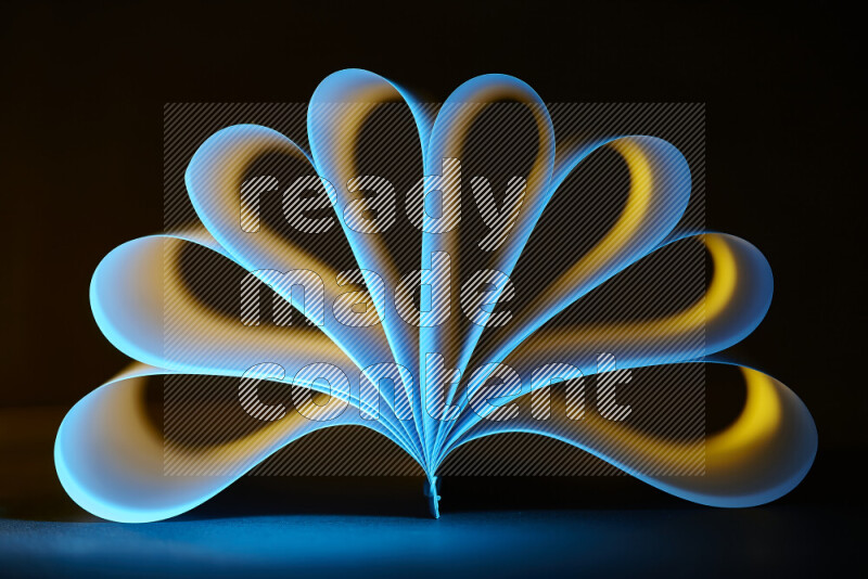 An abstract art piece displaying smooth curves in yellow and blue gradients created by colored light