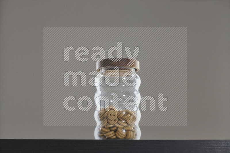 Buttons in a glass jar on black background