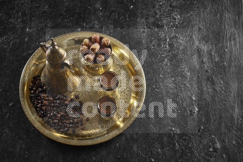 Dates with a drink on a metal tray in a dark setup