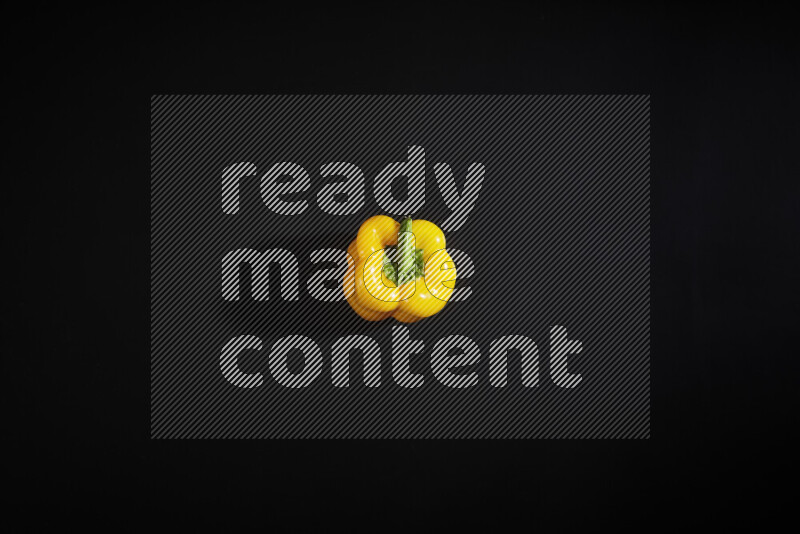 Yellow bell pepper on black background