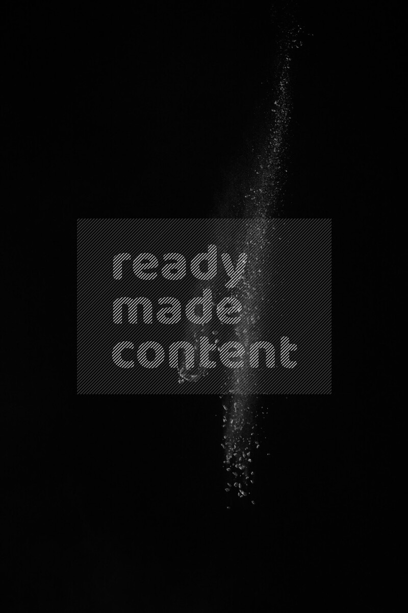 A side view of white powder explosion on black background