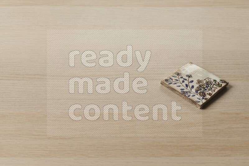 A decorative coaster on light wooden background