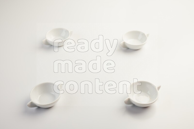 white ceramic round sauce dish on white countertop