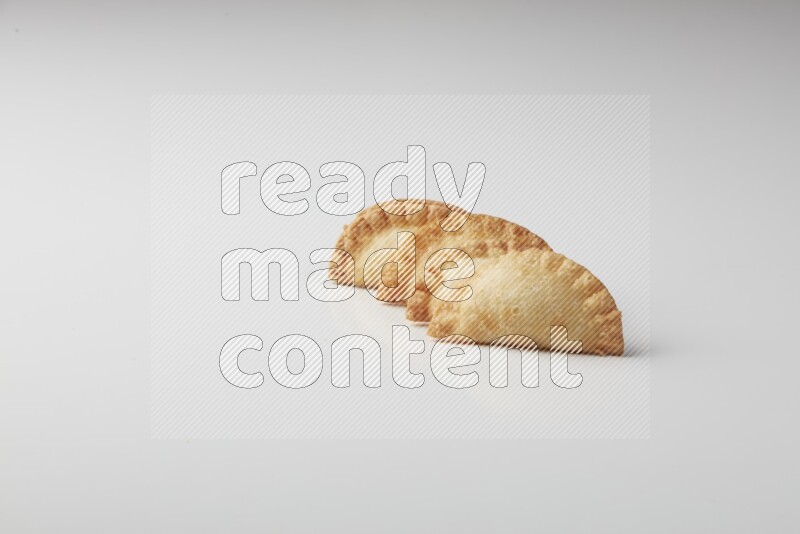 Four fried sambosas on a white background
