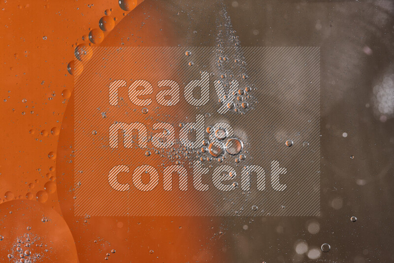 Close-ups of abstract oil bubbles on water surface in shades of orange and brown