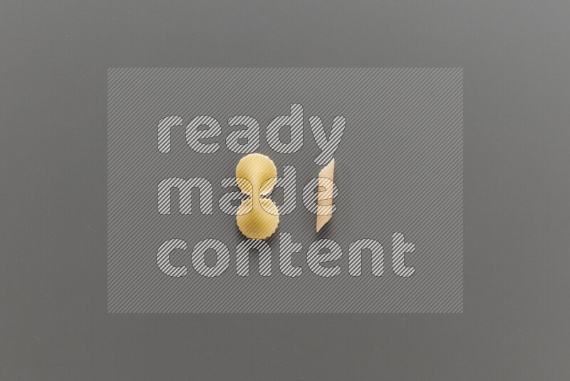Fiocchi pasta with other types of pasta on grey background