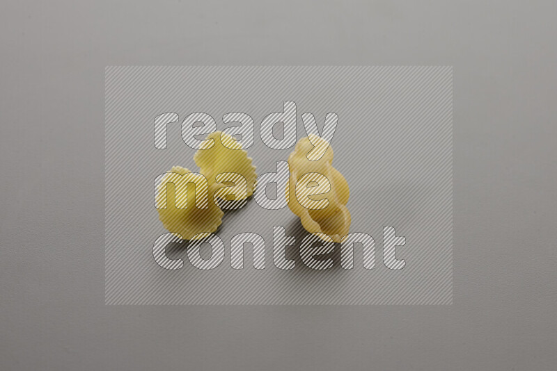 Fiocchi pasta with other types of pasta on grey background