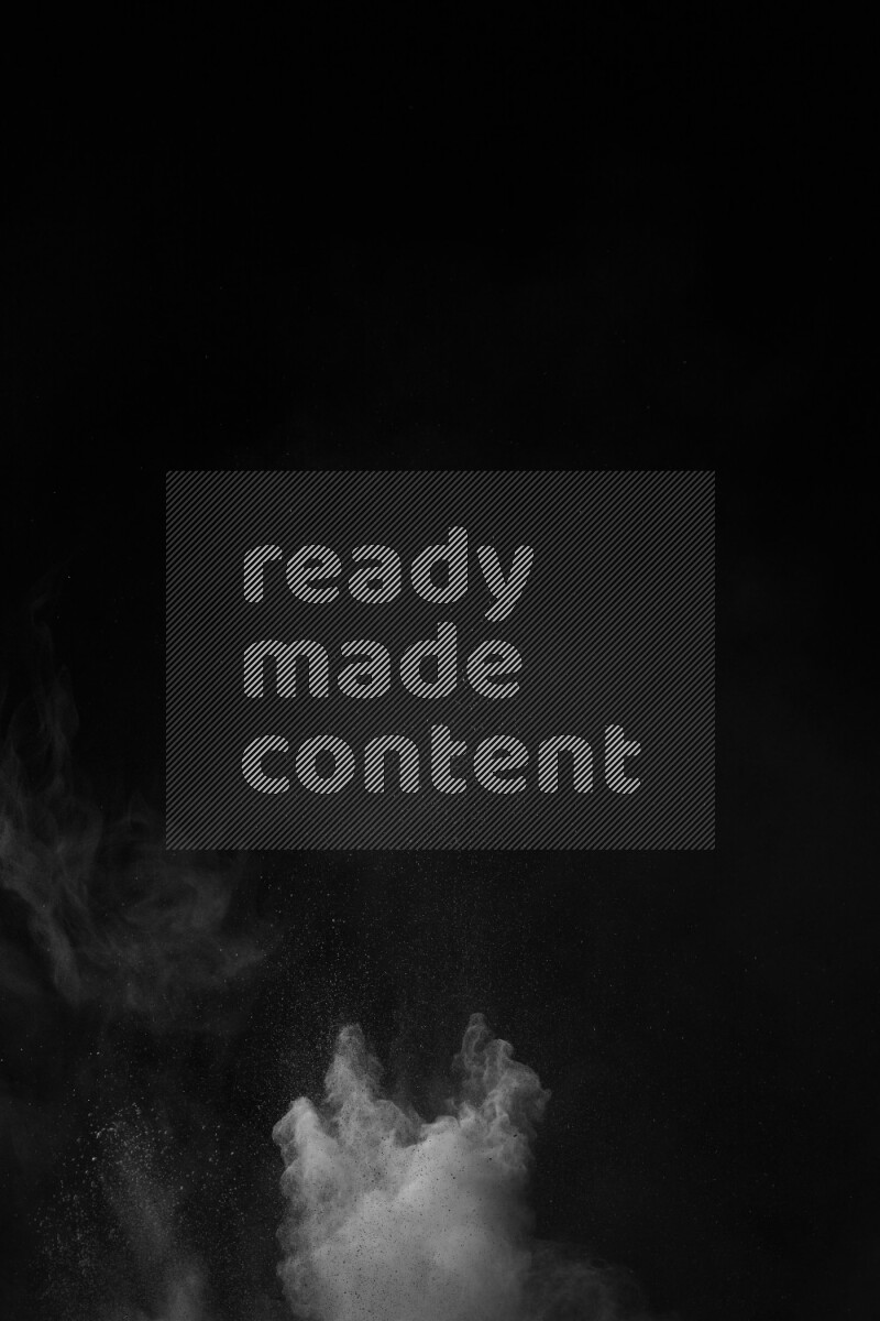 A side view of white powder explosion on black background