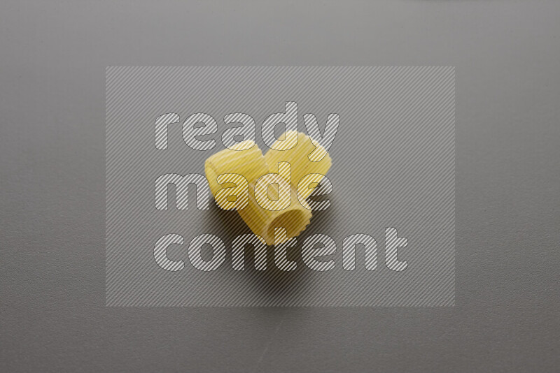 Big rings pasta on grey background