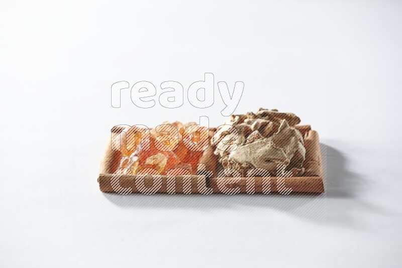 2 squares of cinnamon sticks full of dried ginger and gum arabic on white flooring