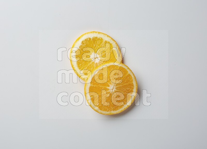Two orange slices on white background