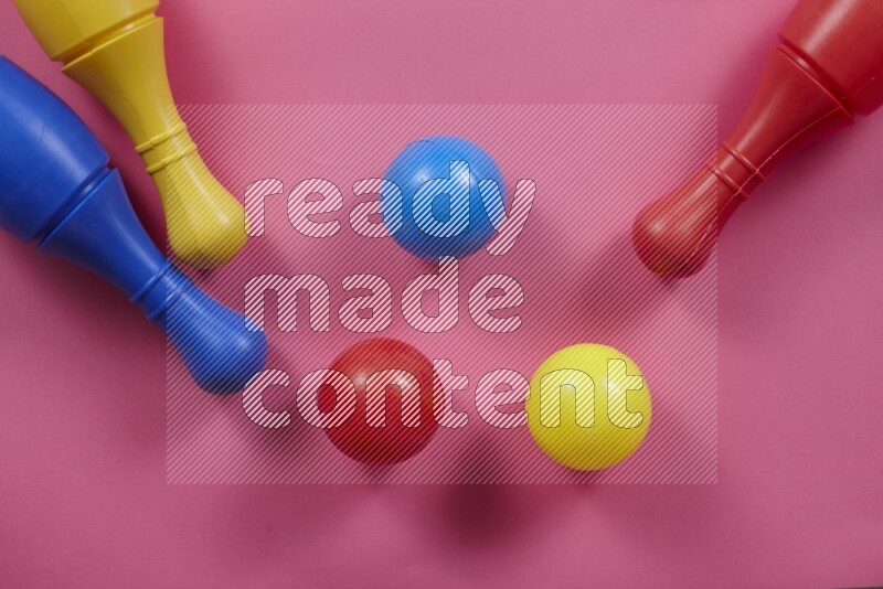 Plastic bowling pins with balls on different colored backgrounds (kids toys)