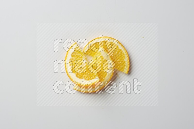 Three halves of an orange slices on white background