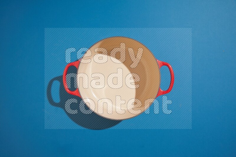 red and white pan and pot on blue background