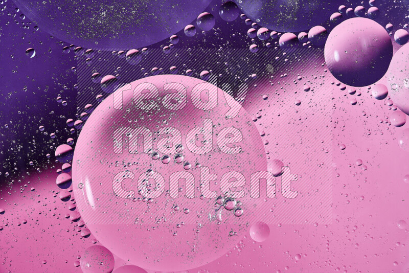 Close-ups of abstract oil bubbles on water surface in shades of purple and pink