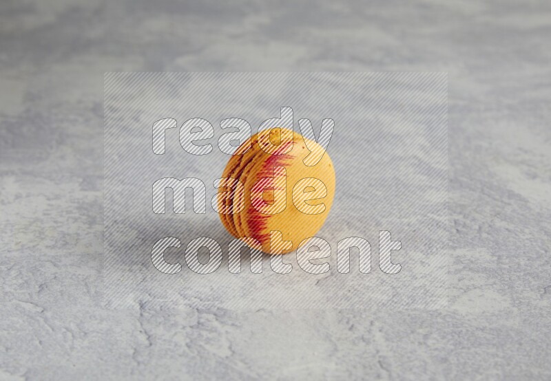 45º Shot of Orange Exotic macaron on white  marble background