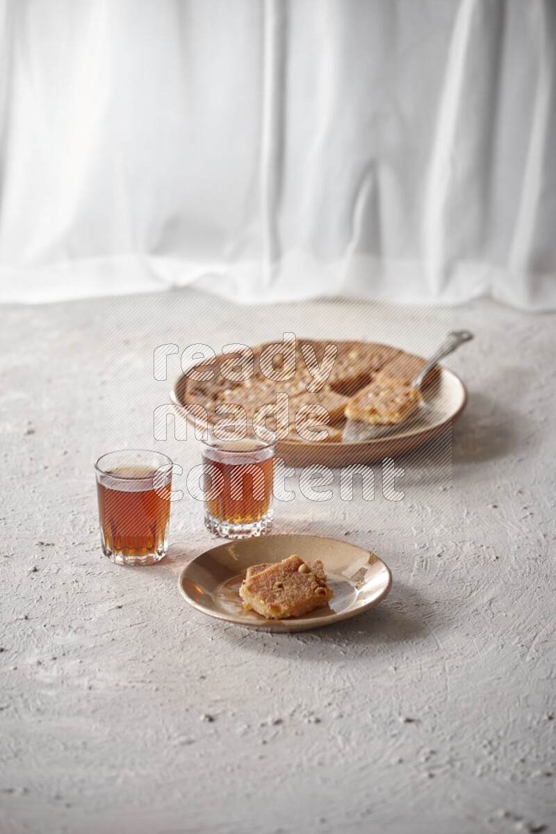 Basbousa with tea in a light setup