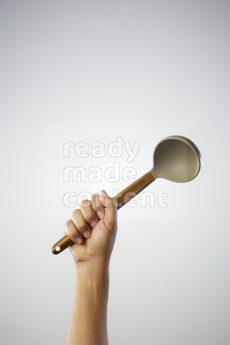 Male Hand Holding ladle on white background