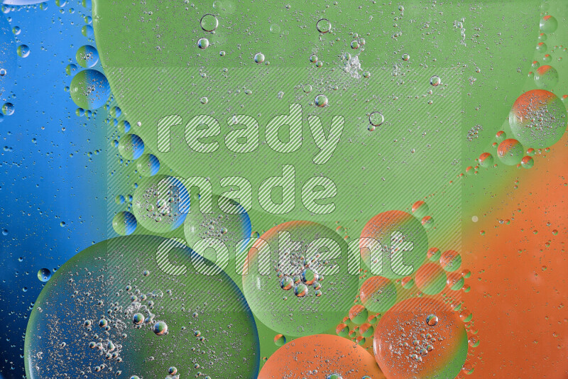 Close-ups of abstract oil bubbles on water surface in shades of orange, green and blue