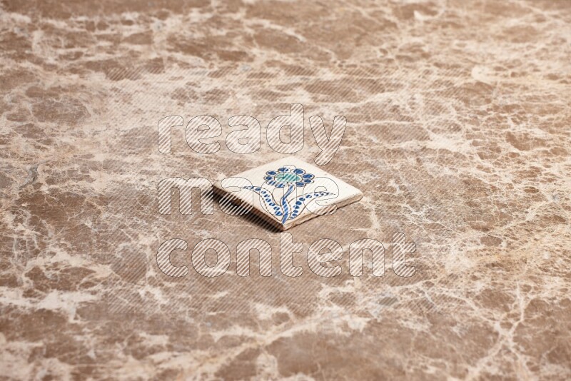 A decorative coaster on beige marble background