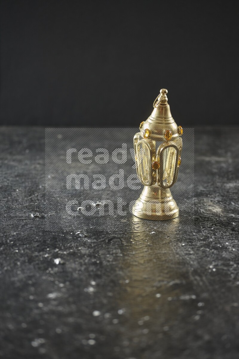 A lantern placed on a textured black background