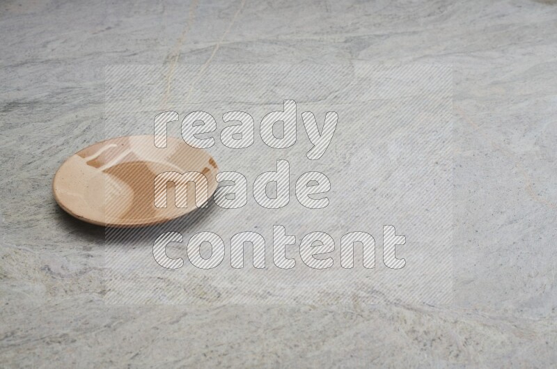 Multicolored Pottery Plate On Grey Marble Flooring