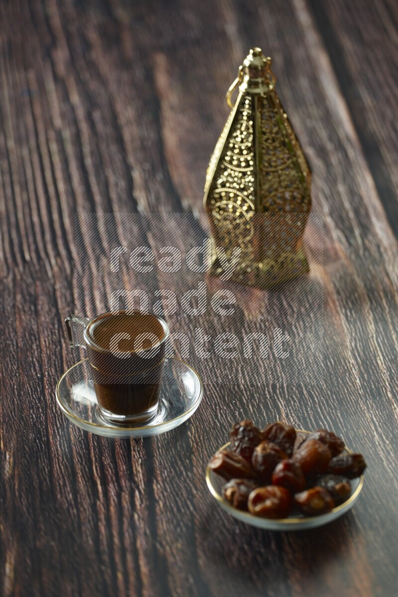 A golden lantern with different drinks, dates, nuts, prayer beads and quran on brown wooden background