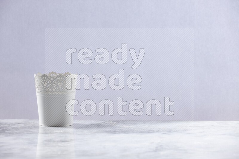 An empty white plant pot on grey marble background