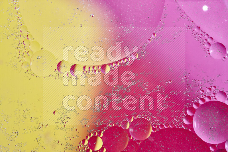 Close-ups of abstract oil bubbles on water surface in shades of yellow and pink