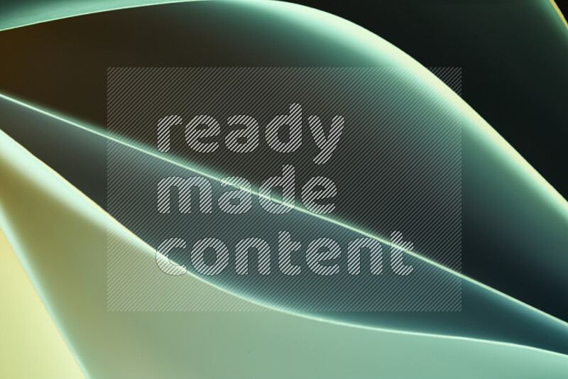 This image showcases an abstract paper art composition with paper curves in green and yellow gradients created by colored light