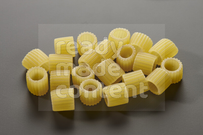 Big rings pasta on grey background