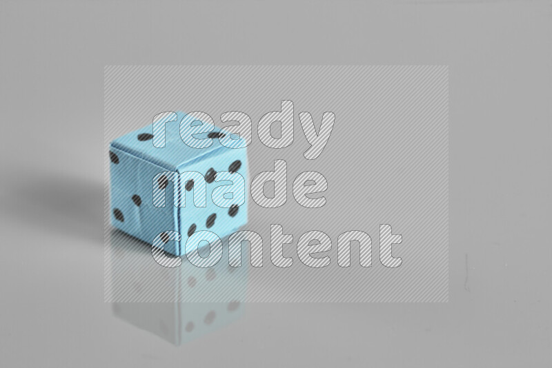 Origami dice on grey background