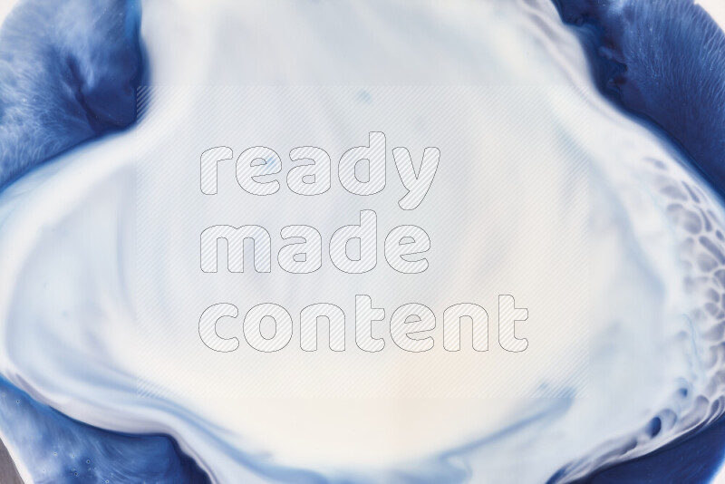 A close-up of abstract swirling patterns in blue and white