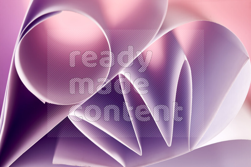 An artistic display of paper folds creating a harmonious blend of geometric shapes, highlighted by soft lighting in purple tones