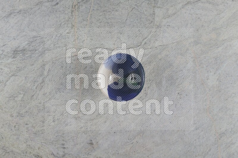 A multicolored pottery Bowl on grey marble background