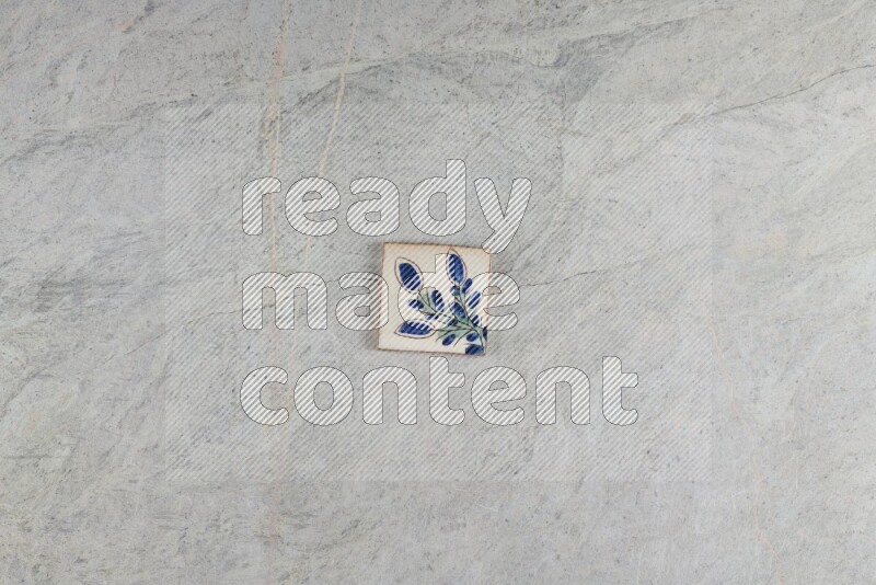 A decorative pottery coaster on grey marble background