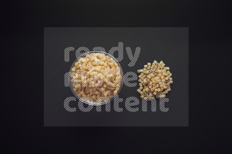 Small rings pasta in a glass bowl on black background