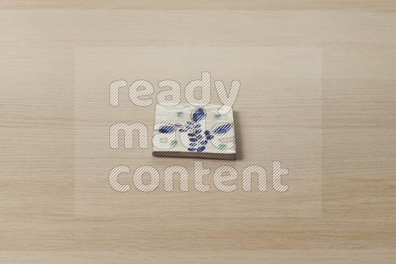 A decorative coaster on light wooden background