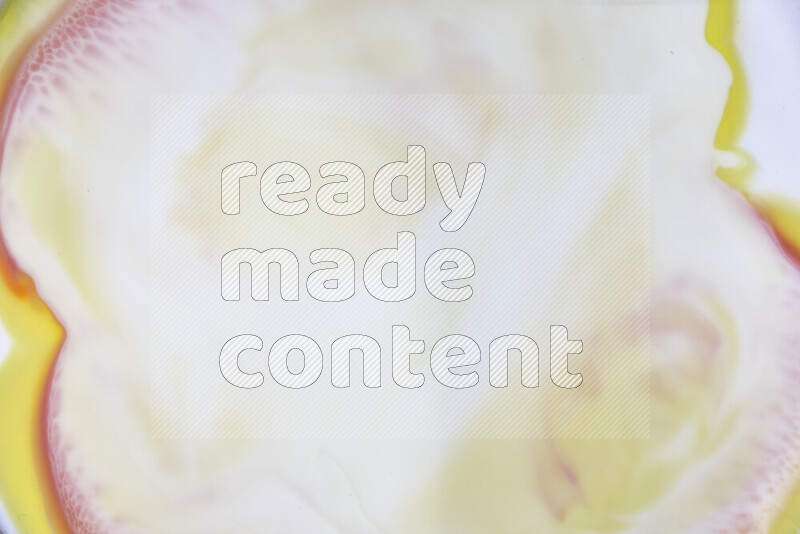 A close-up of abstract swirling patterns in yellow, red and white