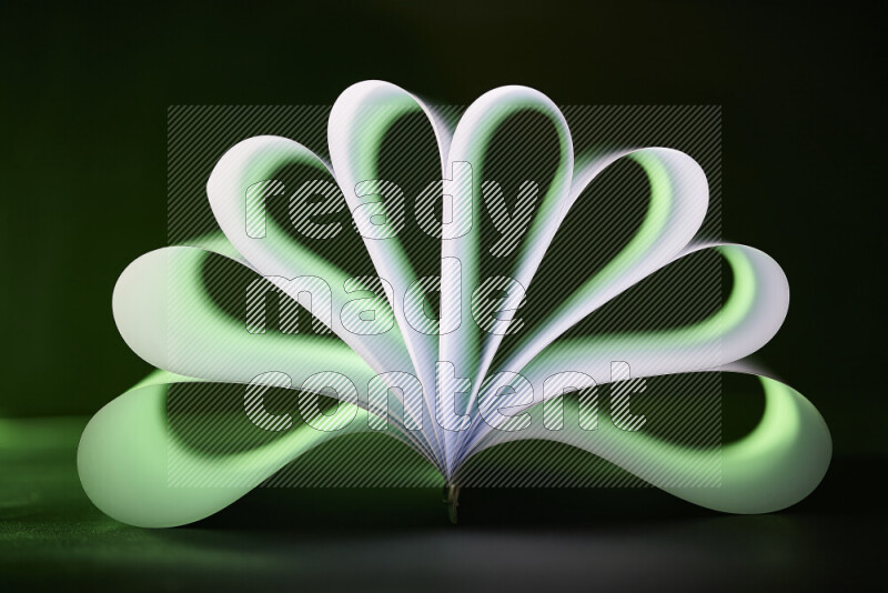 An abstract art piece displaying smooth curves in green and white gradients created by colored light