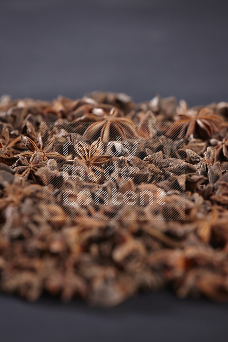 Star Anise herbs fill the frame on black flooring