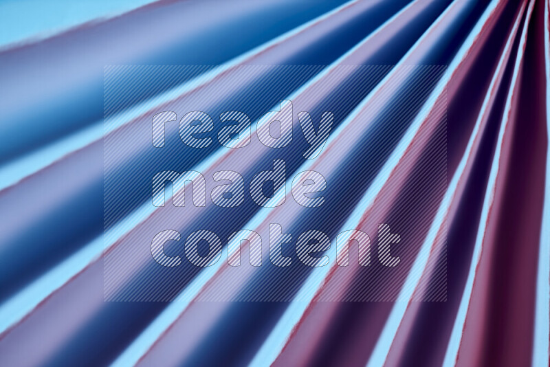 An image presenting an abstract paper pattern of lines in blue and pink tones