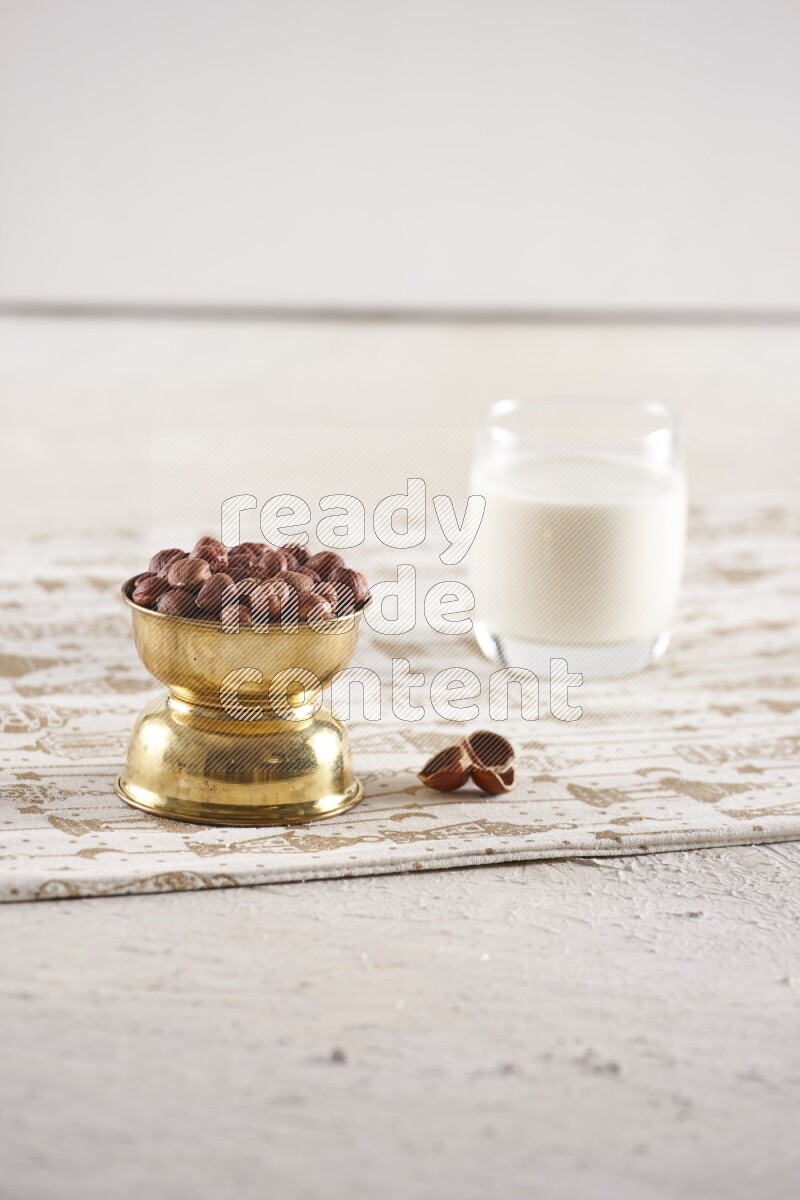 Nuts in a metal bowl with milk a light setup