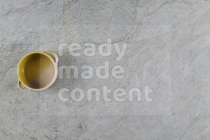 A multicolored pottery Bowl on grey marble background