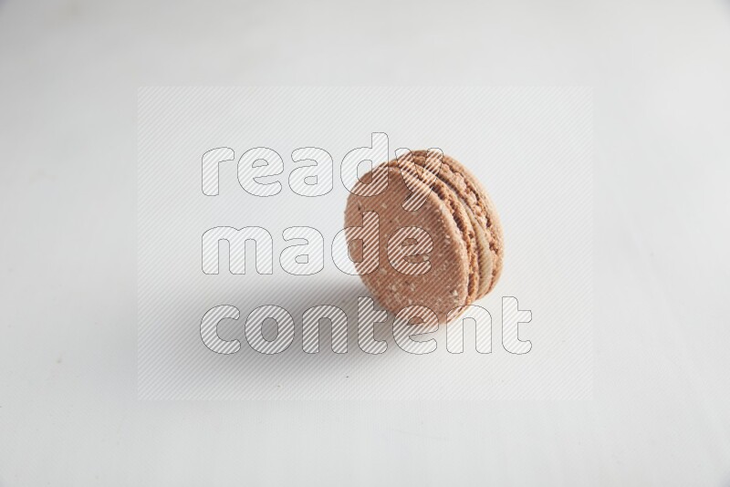 45º Shot of Brown Hazelnuts macaron on white background